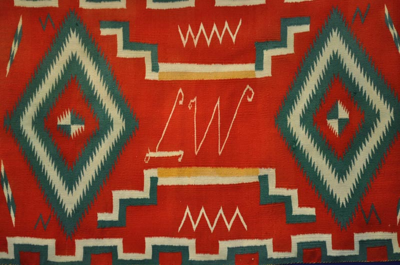 Navajo Germantown runner with initials "LW" in weaving