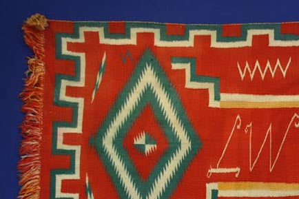 Navajo Germantown runner with initials "LW" in weaving