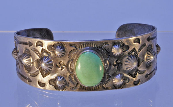 Navajo bracelet with repousse stamp work; Sterling Silver and Turquoise