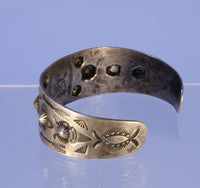 Navajo bracelet with repousse stamp work; Sterling Silver and Turquoise