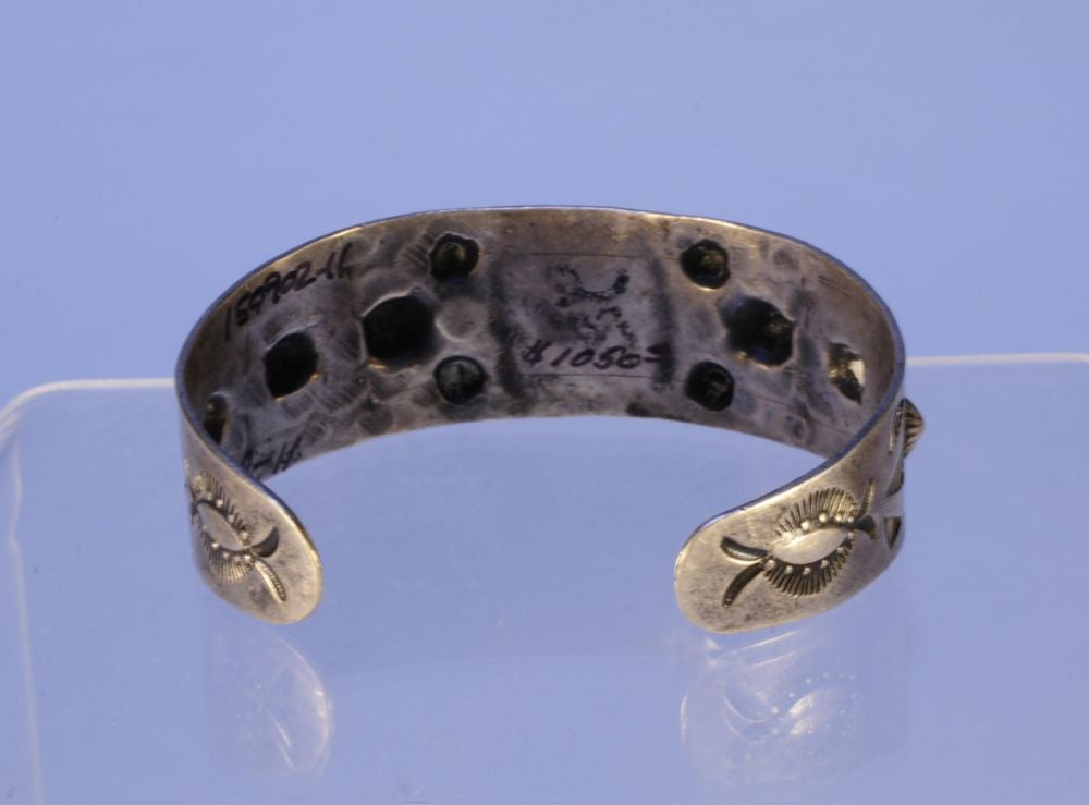 Navajo bracelet with repousse stamp work; Sterling Silver and Turquoise
