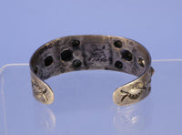 Navajo bracelet with repousse stamp work; Sterling Silver and Turquoise