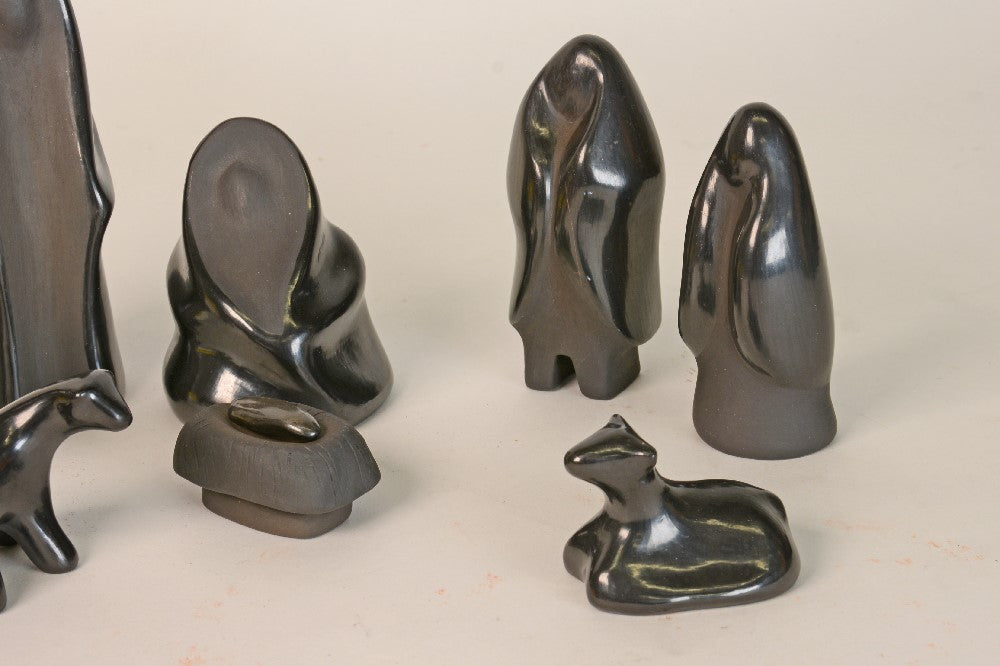 Santa Clara Pueblo Nativity Scene - 8 Pieces (Jesus and Cradle are separate but we will count as 1).  Late 20th century. Tallest Figure 5". With Donkey, Cow, Lamb, Jesus/Cradle, Kneeling Mary, Large Joseph and 2 other human figures.