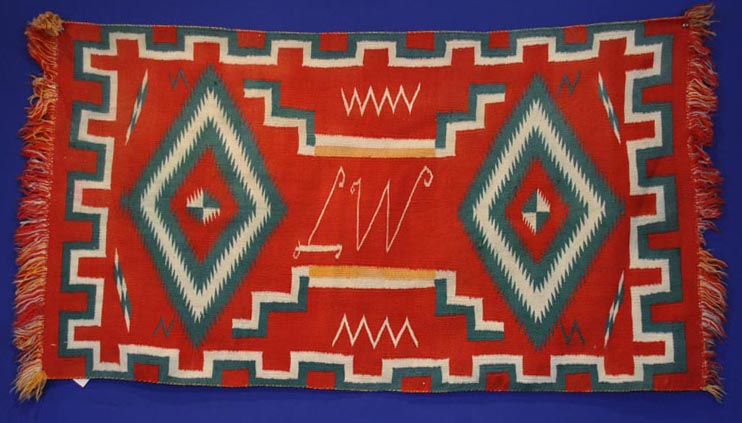 Navajo Germantown runner with initials "LW" in weaving