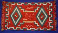 Navajo Germantown runner with initials "LW" in weaving